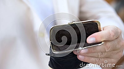 Pensioner holding empty wallet, retirement poverty, high utility rates, payment Stock Photo