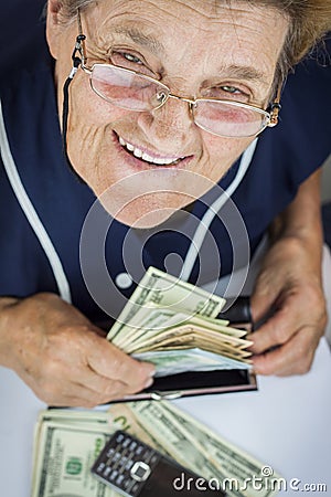 Pensioner holding wallet with money Stock Photo