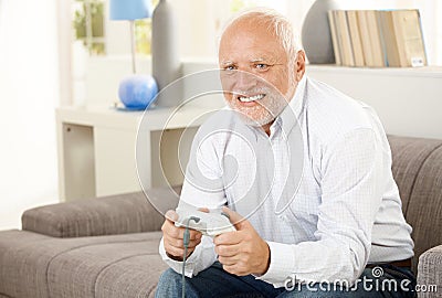 Pensioner playing computer game Stock Photo