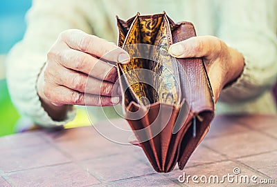 Pensioner woman holding hands wallet without money Stock Photo