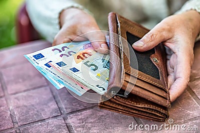 Pensioner woman holding in hands wallet without money Stock Photo