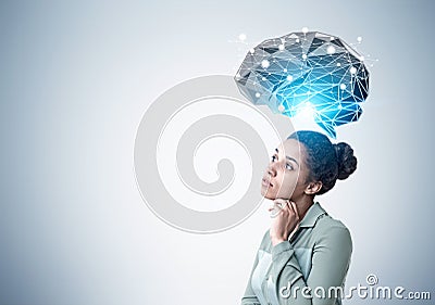 Pensive African American woman and brain hologram Stock Photo