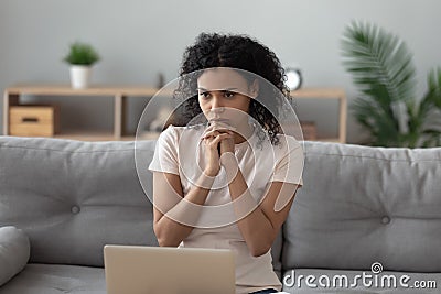 Pensive black girl busy thinking working on laptop Stock Photo