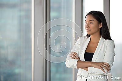 Pensive Asian female employee think of problem solution Stock Photo