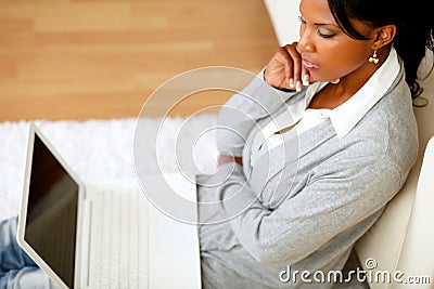 Pensive attractive woman sitting on the floor Stock Photo