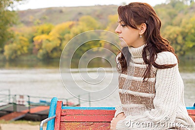 Pensive attractive young woman outdoors Stock Photo