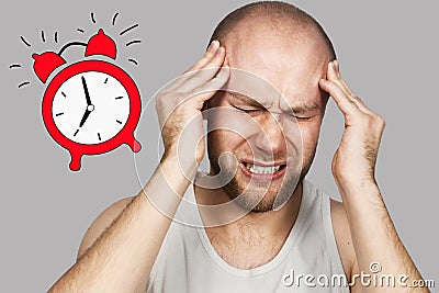 Pensive bald guy sits awake from early morning alarm and is going to work in the office Stock Photo