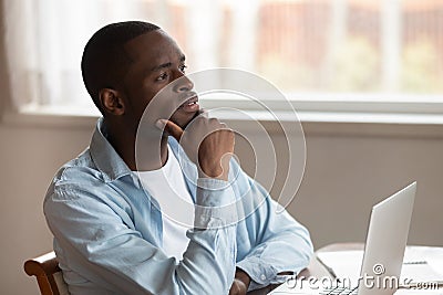 Pensive biracial man distracted from laptop work thinking Stock Photo