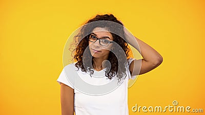 Pensive biracial woman touching back of head, unsure of choice, making decision Stock Photo