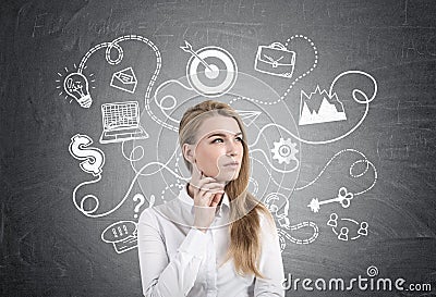 Pensive blonde businesswoman and business plan Stock Photo