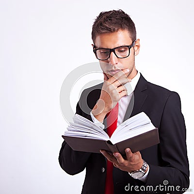 Pensive business man reading a book Stock Photo