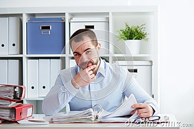 Pensive businessman calculates taxes Stock Photo