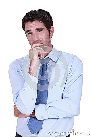 Pensive businessman rubbing chin Stock Photo