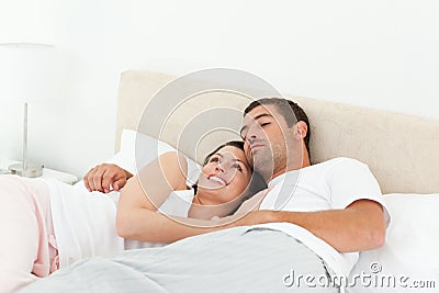 Pensive couple relaxing together lying on the bed Stock Photo