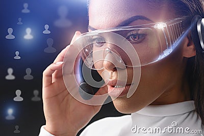 Pensive female operator using technology of the future Stock Photo