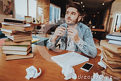 Pensive Freelance Text Writer Sitting at Desk Stock Photo