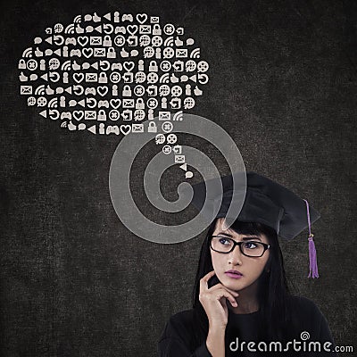Pensive graduate with abstract cloud Stock Photo