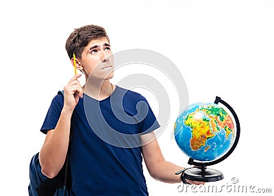 Pensive male student holding globe Stock Photo