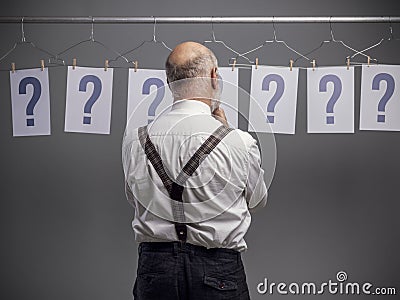 Pensive man comparing different possibilities and questions Stock Photo