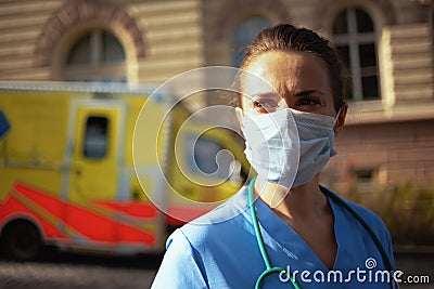 Pensive medical doctor woman with stethoscope and medical mask Stock Photo