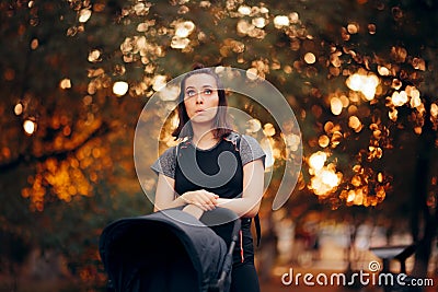 Pensive Mother Thinking While Pushing a Baby Stroller Stock Photo