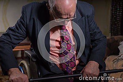 Pensive Old Businessman Sitting on his Wheelchair Stock Photo