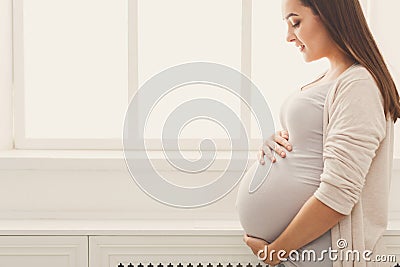 Pensive pregnant woman dreaming about child Stock Photo