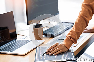 Pensive programmer working on on desktop pc programming code technologies or website design at office Software Development Company Stock Photo