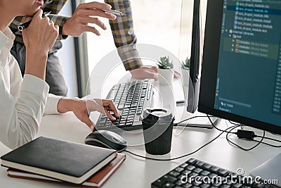 Pensive programmer working on desktop pc programming code technologies or website design at office Software Development Company Stock Photo