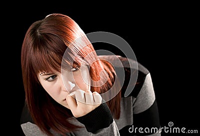 Pensive redhead girl biting nail Stock Photo