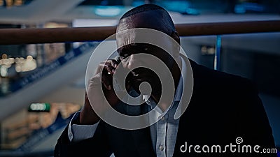 Pensive senior ethnic businessman sad answer call displeased talking mobile phone African American upset frustrated Stock Photo
