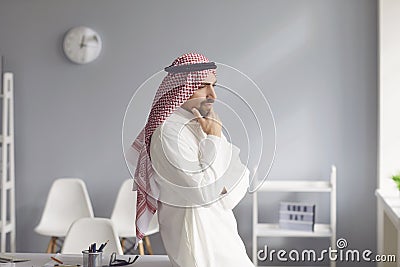 Pensive serious arabic man looks in a white office Stock Photo