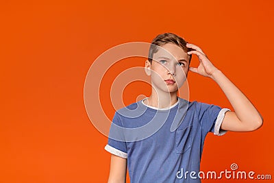 Pensive teenage boy looking up with thoughtful expression Stock Photo
