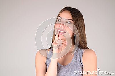 Pensive woman isolated on studio background thinking. Thoughtful woman planning problem solution, lost in thoughts Stock Photo