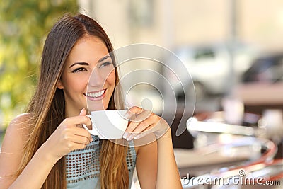 Pensive woman thinking in a coffee shop terrace Stock Photo