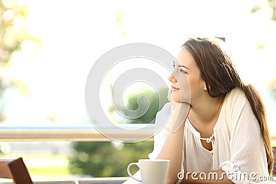 Pensive woman thinking and looking at side Stock Photo