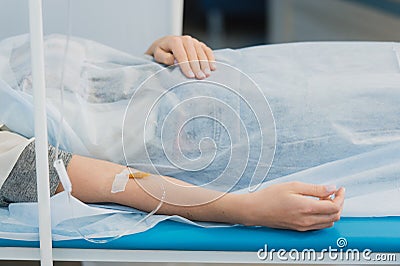 Pensive woman transfused lying in hospital ward Stock Photo