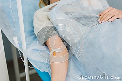 Pensive woman transfused lying in hospital ward Stock Photo