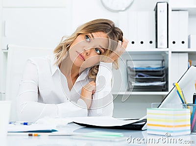Pensive young girl in business clothes in modern office Stock Photo