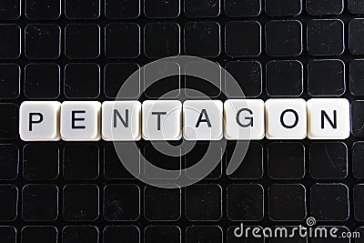 Pentagon title text word crossword. Alphabet letter blocks game texture background. White alphabetical letters on black Stock Photo