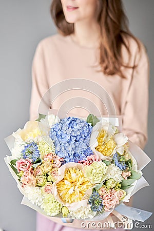 Peonies and hydrangea. Beautiful bouquet of mixed flowers in woman hand. Floral shop concept . Handsome fresh bouquet Stock Photo