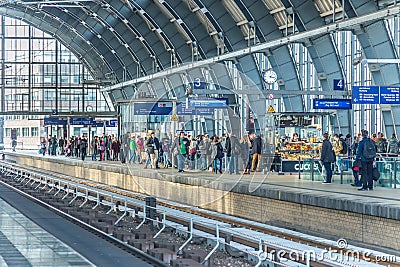 peope travel at Alexanderplatz subway station in Berlin, Germany. Its a large public square and transport hub in the central Mitte Editorial Stock Photo
