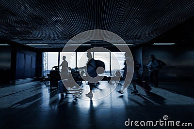 People at an airport terminal, waiting for departure time, motion blur shot Stock Photo