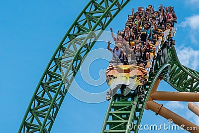 People amazing terrific Cheetah Hunt rollercoaster on lightblue cloudy sky background 71 Editorial Stock Photo