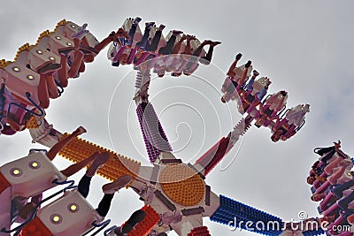 People amuse themselves in a fun fast moving fairground attraction Editorial Stock Photo