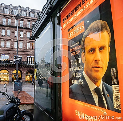 People with anti-Covid-19 masks on French city Street with portrait of French Editorial Stock Photo