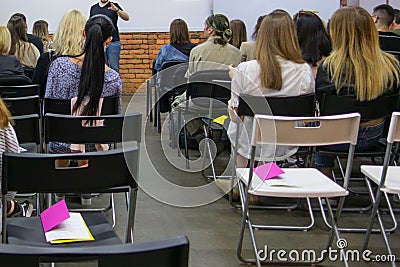 People in auditory during presentation or seminar. Teenagers or young men and women at university lecture or seminar. Back side Editorial Stock Photo