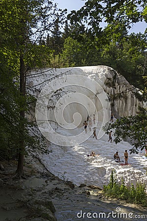 People bathing in Bagni San Filippo natural thermal pools Editorial Stock Photo