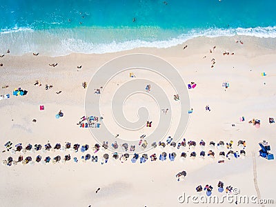 People bathing in the sun, swimming and playing games on the beach. Tourists on the sand beach in Kefalonia island, Greece Stock Photo