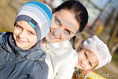 3 people beautiful young mother with two children, son and daughter having fun happy smiling & looking at camera, closeup portrait Stock Photo